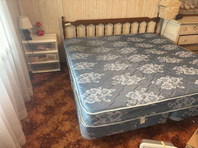 Vintage king size bed with wood headboard, assortment bin, and side table lamp image