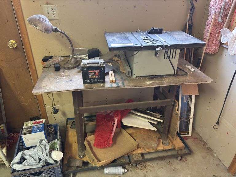 Small table saw on heavy duty work stand with rolling carts image
