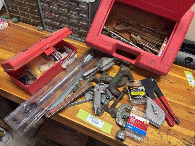 Assortment of hand tools, pipe wrench, chalk line, rivet tool, speed square, large torque wrench image