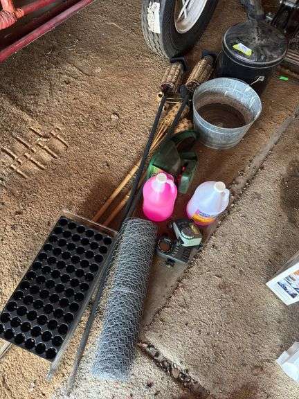 Galvanized bucket, tiki torches, hand spreader, RV antifreeze, sprinkler, timers, seed starter image