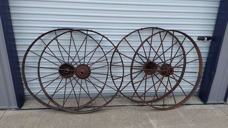 Set of (4) GIANT 44" Antique Buggy Steel Wheels (yard art wagon build garden decoration landscape). Left set(2): 44"dia, 3"W tread (convex). Right set(2): 44"dia, 2.5"W tread (concave). All are in standard antique condition, rust patina, 3 wheels intact with no major damage, 4th wheel has chunk taken out of the hub (see photo) but does not affect structural integrity. image