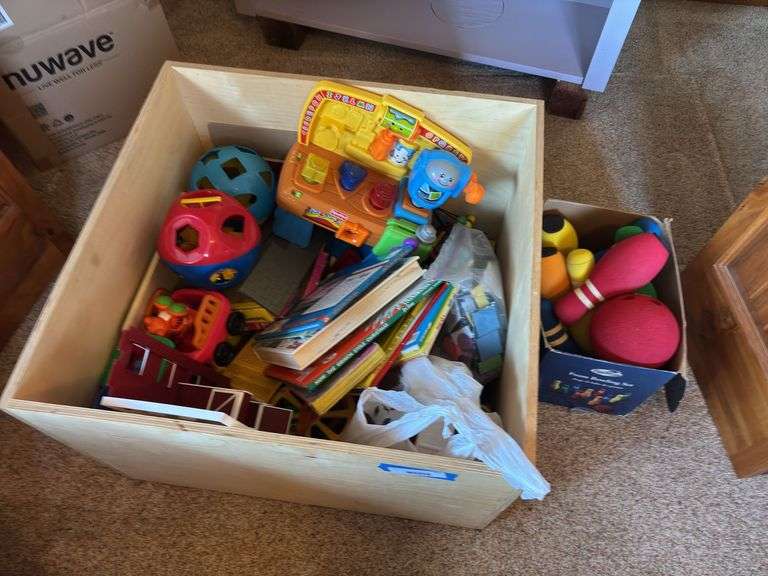 Large wooden box full of kids toys, and books
