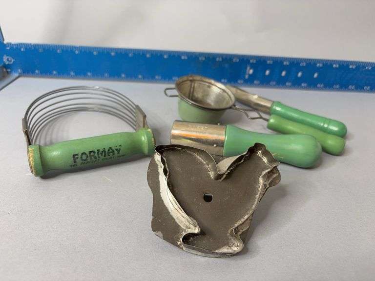 Vintage green handled kitchen tools and chicken cookie cutter image