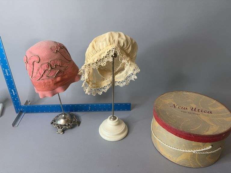 Two hat stands w hats and New Utica Des Moines hat box image