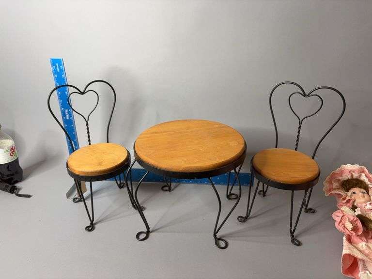 Doll size table with two chairs and two porcelain dolls, set up for tea image
