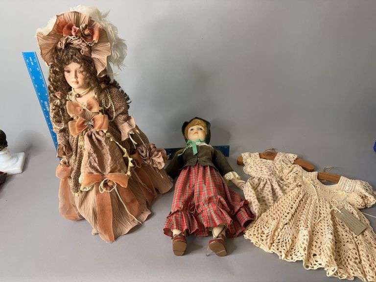 Two bisque dolls and an extra dress for each image