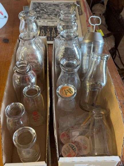 Various size dairy bottles and accessories image