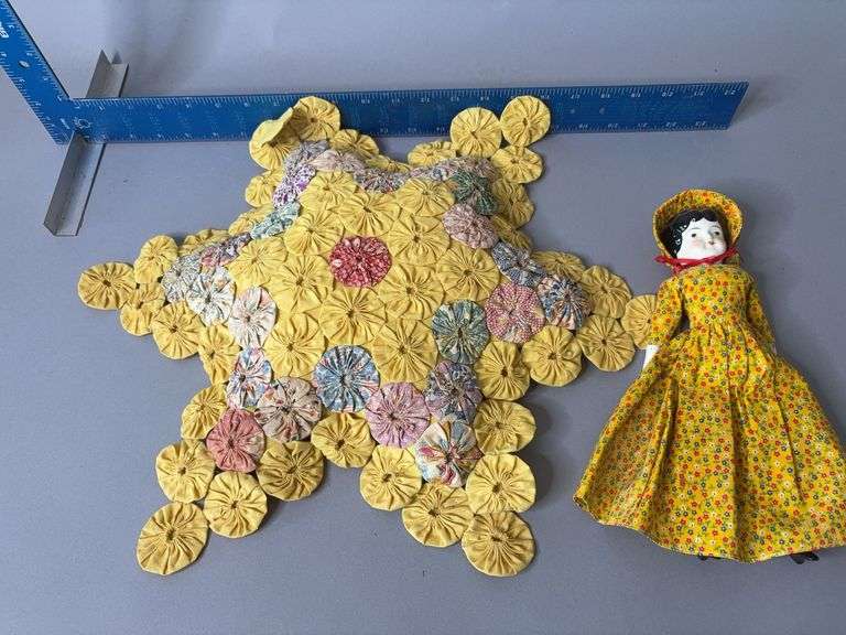 Minerva doll with yo-yo star pattern quilted pillow image