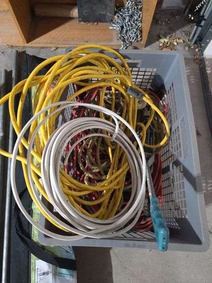 Milk crate full of extension cords and cable come along image