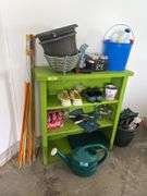 Green bookshelf and gardening items, shoes, fiberglass driveway markers, sprinkling cans etc...