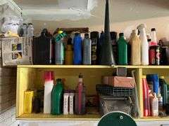 Shelves of auto and garage fluids and supplies, plus small live trap
