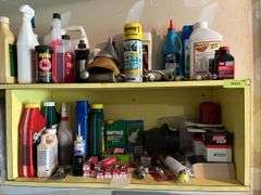 Shelves of auto and garage fluids and supplies, plus small live trap