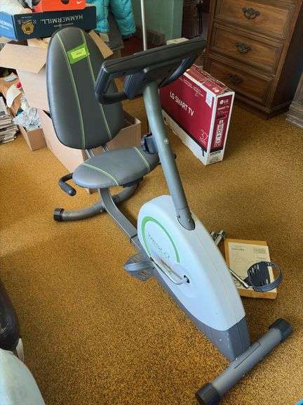 Weslo Pursuit 360R exercise bike and a pair of stainless steel dumbbells