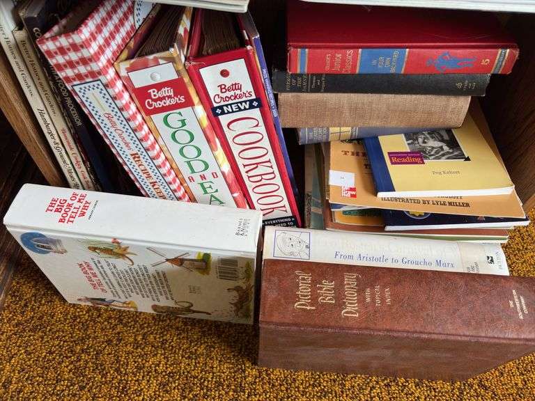 Small bookcase full of all kinds of reading materials