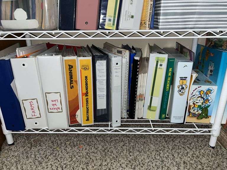 White metal shelf unit full of education materials BRING YOUR BOXES