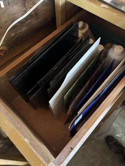 Four drawer file cabinet full of glass pieces