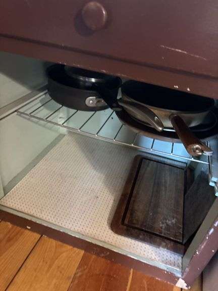 Small cupboard with enamel top and some cookware