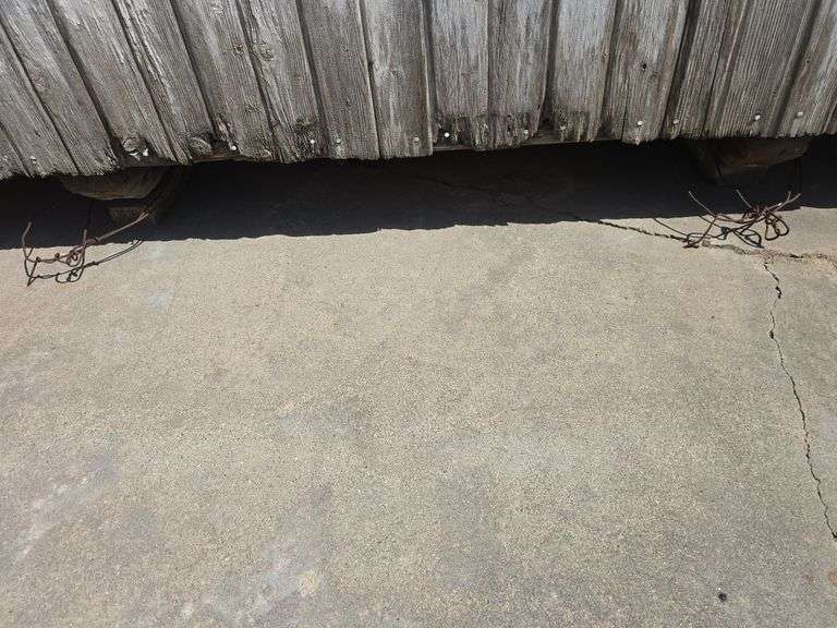 12' x 12' portable granary shed on skids, sitting on concrete pad, interior is lined for grain storage, buyer will have 30 days to remove