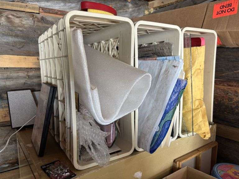 Four drawer file cabinet full of glass pieces