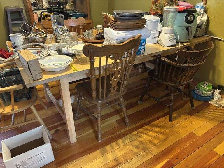 Large light pine dining room table with one self storing leaf and 5 mismatched chairs