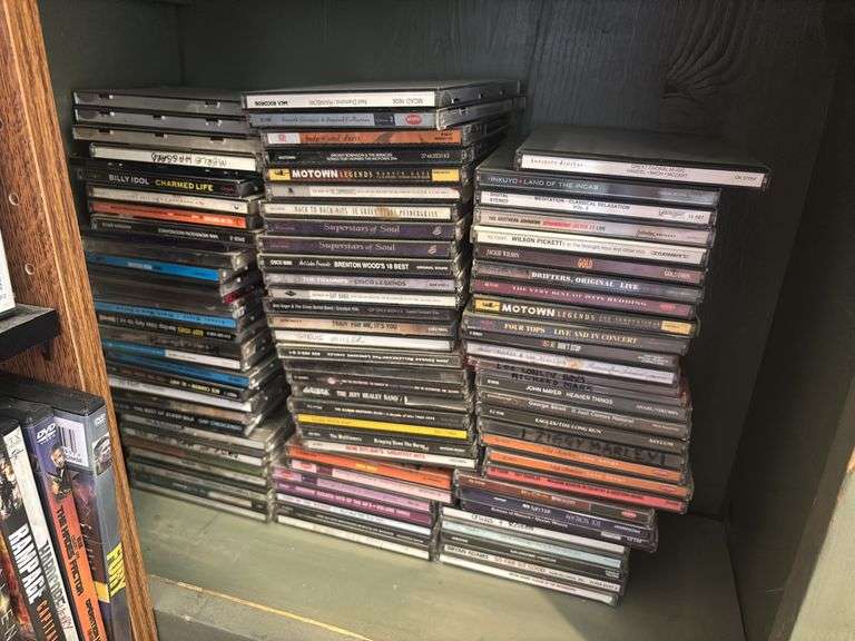 Two shelves full of DVDs and CDs
