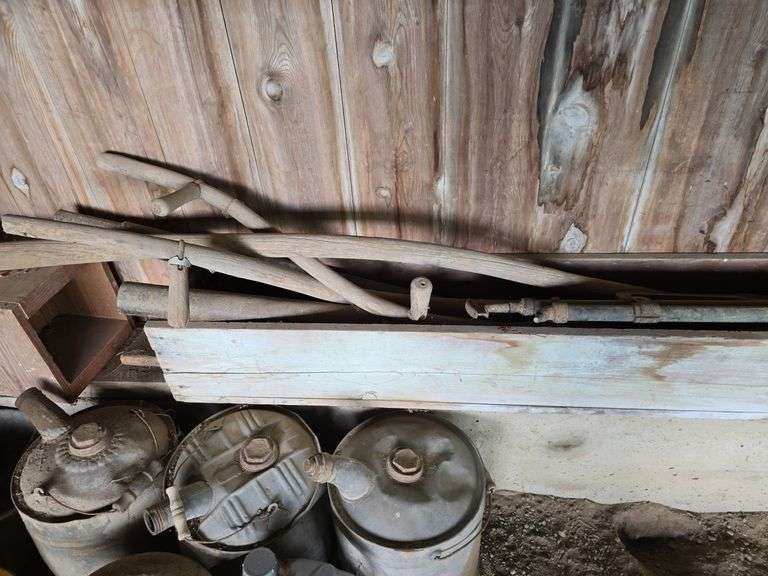 Oil, old gas cans, buckets, cast iron skillet, nails and more All on and under shelf