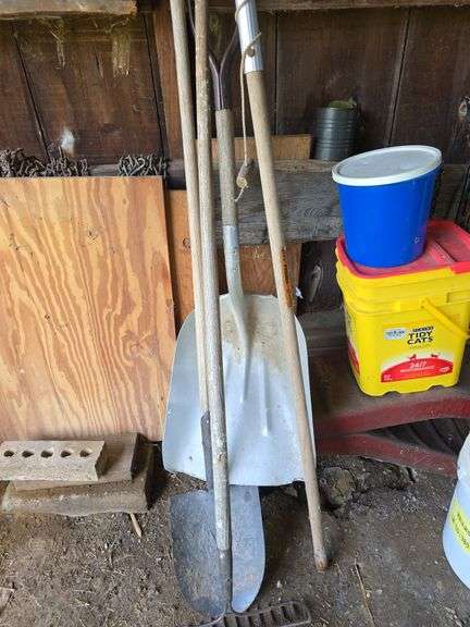 Car ramps, log chain, tire chains, scoop shovel, grease gun, large roll of plastic sheeting
