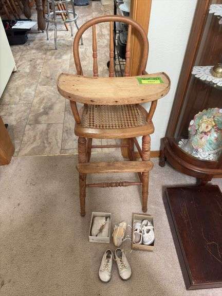 Antique wooden high chair and baby shoes Per Seller dates back to 1877