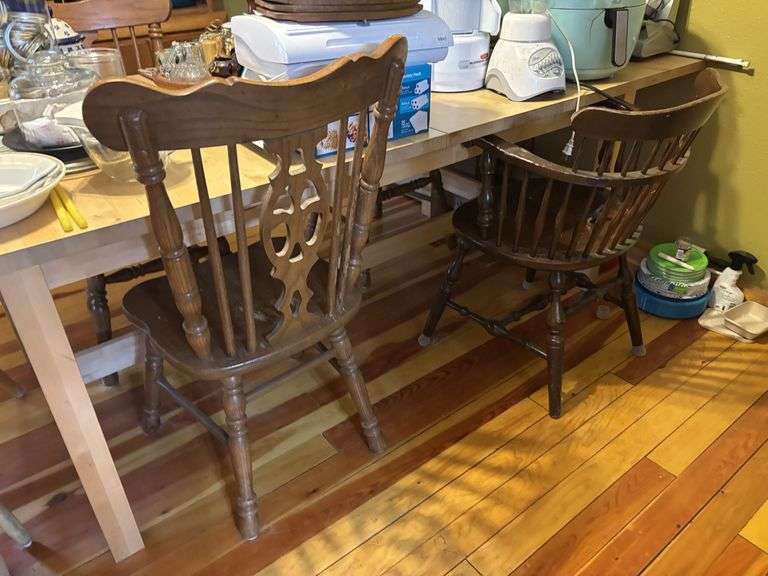 Large light pine dining room table with one self storing leaf and 5 mismatched chairs