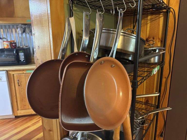 Cookware hanging on shelf - lots of skillets