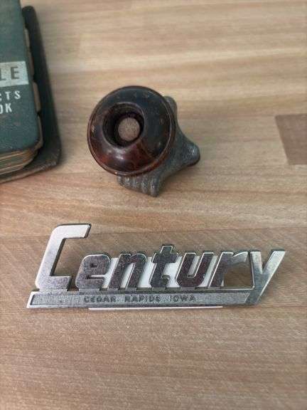 Steering wheel knob, Century Cedar Rapids, Iowa car emblem and 1959 Futuramic Oldsmobile handbook