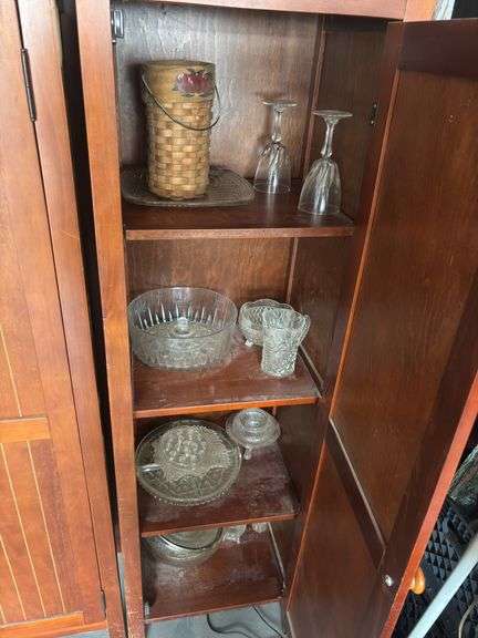 Two storage cupboards (one missing handle) and glassware contents