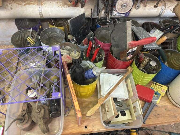 Large quantity of hand tools on top of bench
