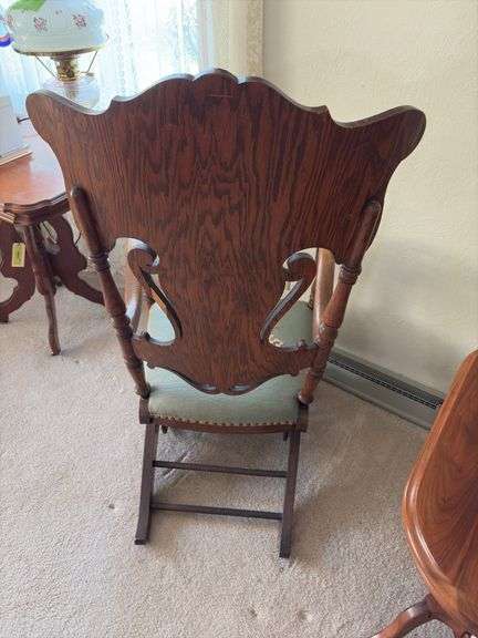 Antique oak platform rocker with needlepoint seat, veneer has small chip on back