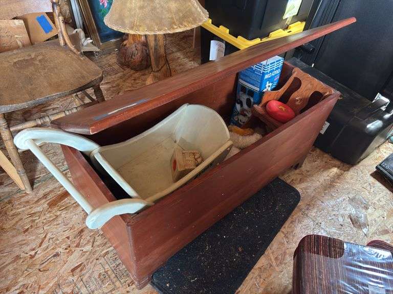 Wooden toy chest with bear buggy and assortment of stuffed animals