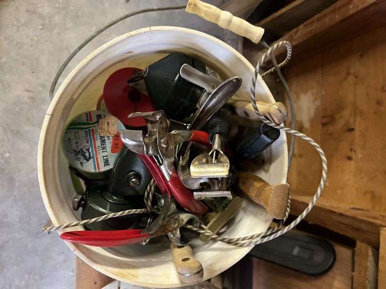 Various fishing poles, dip nets, reels, cleaning supplies