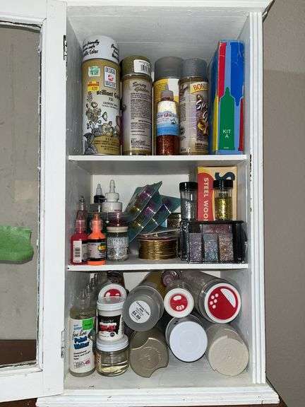 10D x 14L x 24H old wooden cabinet full of paints, glitter, etc...