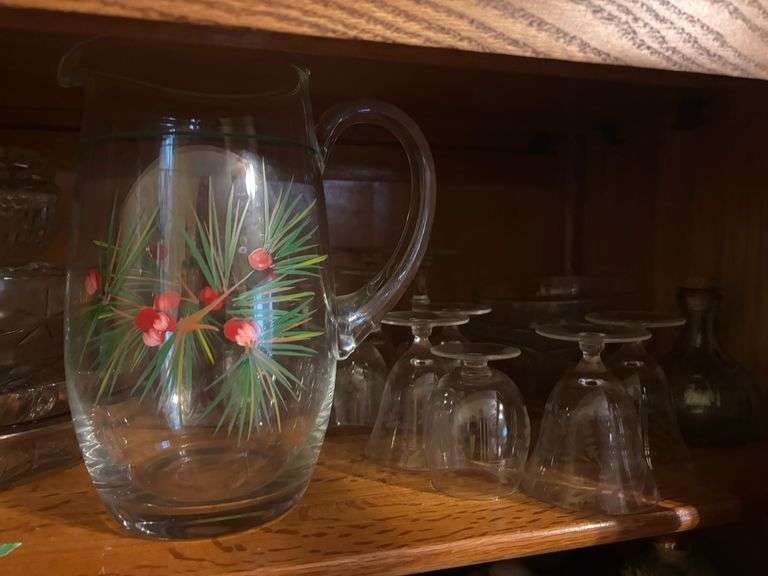 Two shelves of glassware - juice pitcher, soup bowls, cups, trays, china items