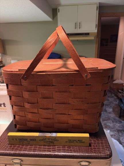 Vintage suitcase, picnic basket and wooden Coast to Coast level