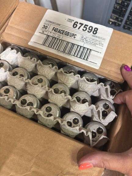Corner of shop, including large box of new fluorescent bulbs