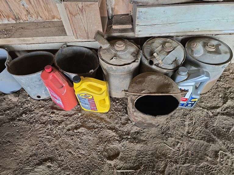 Oil, old gas cans, buckets, cast iron skillet, nails and more All on and under shelf