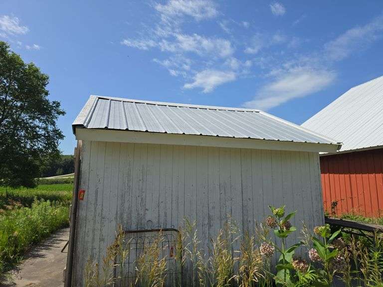 12' x 12' portable granary shed on skids, sitting on concrete pad, interior is lined for grain storage, buyer will have 30 days to remove