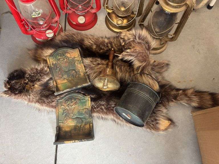 Four modern lanterns, brass bookends, brass school bell, raccoon hides