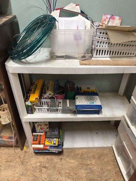 Three small shelves with assorted craft items