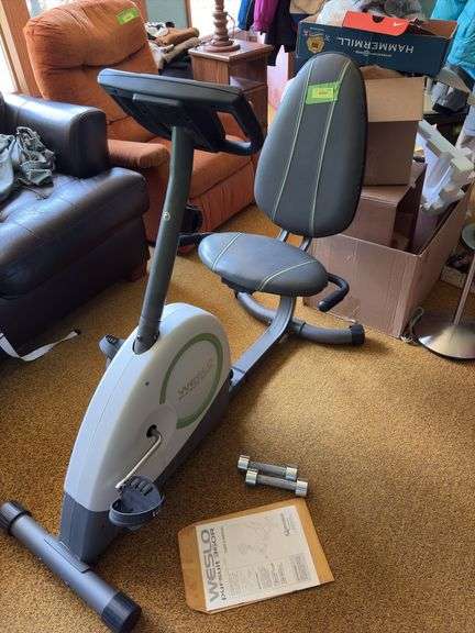 Weslo Pursuit 360R exercise bike and a pair of stainless steel dumbbells