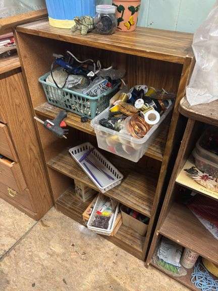 Three small shelves with assorted craft items
