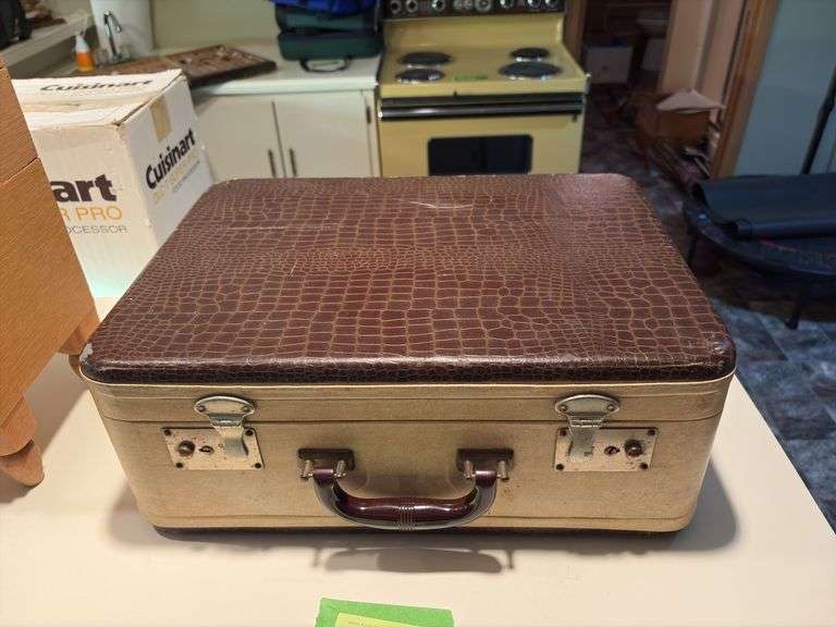 Vintage suitcase, picnic basket and wooden Coast to Coast level