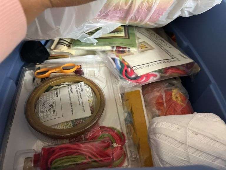 Tote of wood craft items, embroidery kits and string and a box of paper, tins and misc