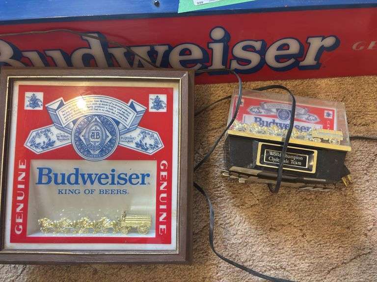 Three lighted Budweiser signs large sign does have some damage