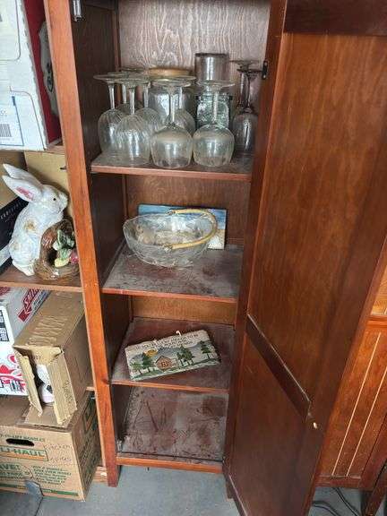 Two storage cupboards (one missing handle) and glassware contents
